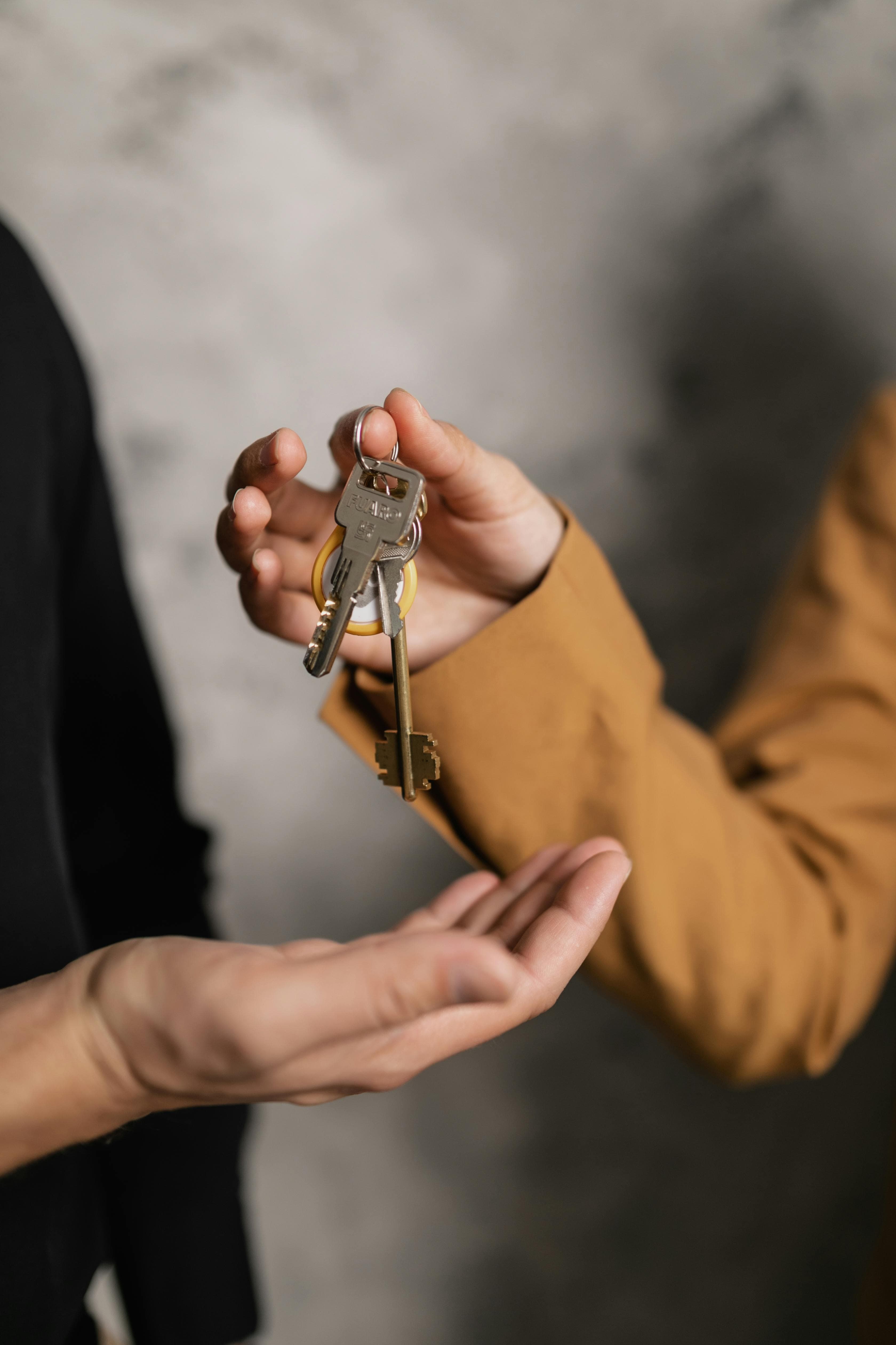 Hands exchanging keys at a counter